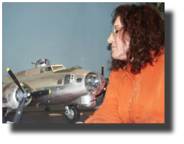 Clarisa Rojas Bazán staring at the all metal B-17 scale model.